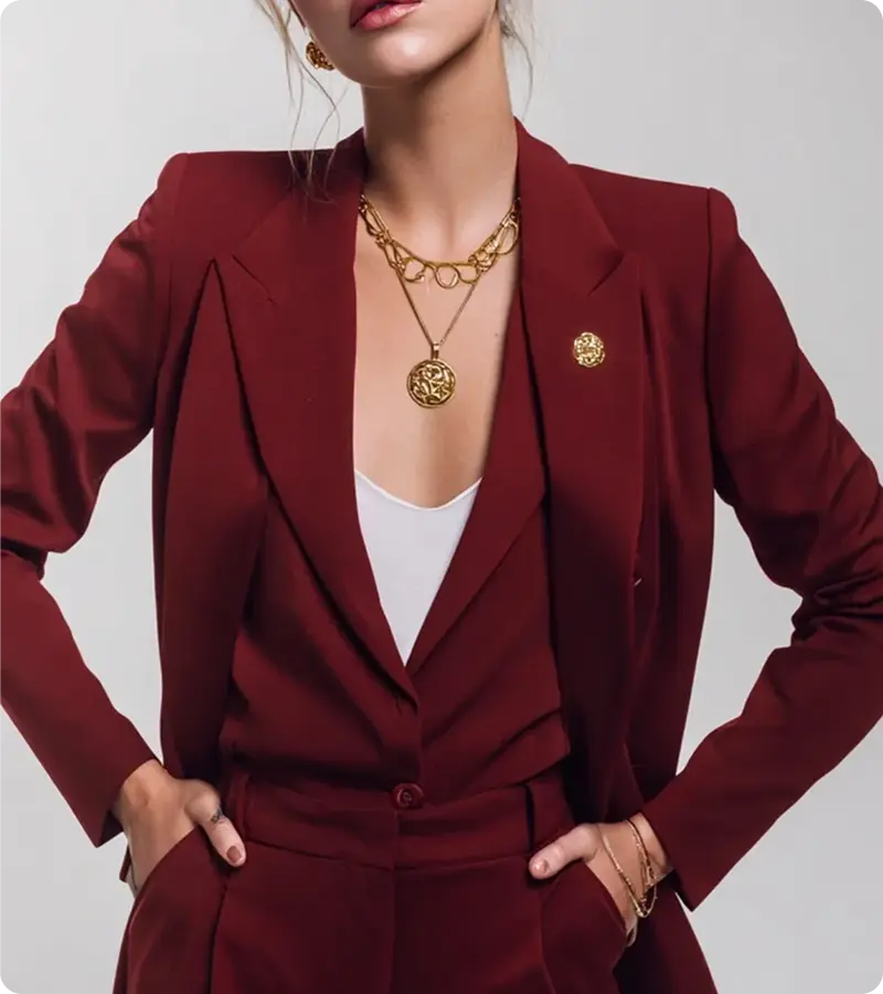 Woman in red suit with gold jewelry